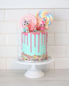 there is a cake decorated with lollipops and candy