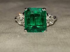 GORGEOUS 14K white gold emerald  engagement ringcenter Lab Flux Growth EMERALD COLOMBIA BERYL EMERALD weight 3.18ct. size 10.7X9.4X3.9mmnice vivid green color ,clean, very lively ,nice cut .side two round diamonds total weight 0.85ct H-SI1Ring SIZE 6.5Resizable Retail value $8,500 net.Cert Appraisal available Green Diamond Ring With Vvs Clarity And Radiant Cut, Green Asscher Cut Emerald Ring With Accent Stones, Radiant Cut Green Emerald Ring In Platinum, Green Asscher Cut Diamond Ring In Platinum, Green Emerald Cut Platinum Rings, Green Platinum Ring With Emerald Cut, Platinum Emerald Ring With Radiant Cut, Emerald Cut Green Platinum Rings, Green Asscher-cut Platinum Diamond Ring