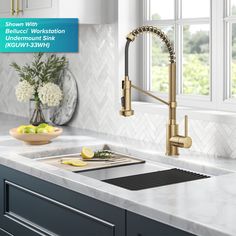 an image of a kitchen setting with marble countertops and gold faucet sink