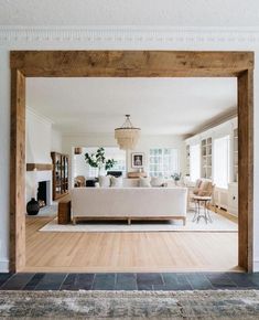 a living room filled with furniture and a fire place in the middle of a room