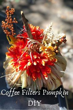 coffee filterr's pumpkin diy with fall flowers and berries in the background