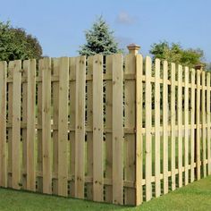 a large wooden fence in the grass