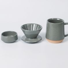 three cups and saucers sitting next to each other