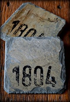 two rocks with numbers on them sitting on a table