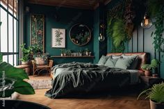 a bedroom with green walls and wooden flooring, plants in the window sill