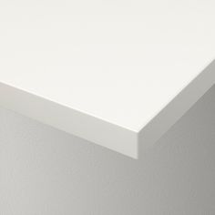 a close up view of a white surface on a wall with no one around it