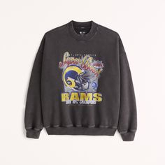 Step into the past with style in the Men's Vintage Rams Graphic Crew Sweatshirt by Abercrombie & Fitch. This piece combines nostalgia with modern comfort, making it a must-have for any wardrobe.

- Size: Medium
- Color: Dark Grey
- Material: Cotton, Polyester
- Gender: Male
- Features: SoftAF fleece fabric, oversized-fit silhouette, vintage Los Angeles Rams graphic on chest, crew neckline, banded hem and cuffs

Perfect for casual outings or game day, this sweatshirt offers both warmth and a touc Throwback Logo Print Sweatshirt For Fall, Graphic Print Sweats For Sports Season Streetwear, Fall Throwback Logo Print Sweatshirt, Collegiate Graphic Print Crew Neck Sweats, Oversized Crew Neck Sweats For Sports Season, Oversized Throwback Fall Tops, Oversized Throwback Top For Fall, Collegiate Crew Sweatshirt With Graphic Print, Varsity Style Crew Neck Sweats With Graphic Print