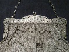 Wonderful Vintage Sterling Mesh purse with Hand cut-out pierce floral open work handle by  Ernst Gideon Bek, Inc.,15 Maiden Lane, New York.. Circa 1890's to 1910. it is marked Sterling and has a butterfly for the markers mark I will try to add the maker later if I find out who it was. It's weight is approximately 212.8 grams. The purse is approximately 6.25" wide across the handle by 5.75" tall from the handle down without counting the chain. The sterling chain is about 16" long. It is in Great Victorian Purses, Mesh Bags, Couture Bags, Vintage Purses, The Maker, Beaded Bags, Mesh Bag, A Butterfly, Vintage Bags