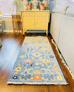 a blue and yellow area rug in a living room