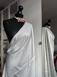 White and silver soft silk saree with an all over sheen. The perfect saree for parties and all traditional events. Versatile saree that can be styled with other blouses or same colour as saree. Message us for personalised bridesmaid saree quotes.   Blouse: unstitched, same fabric and colour as saree   #whitesaree #silversaree #whitesoftysilk   #silksareelook #softsilksaree #sareetrends #kuberapattu Festive Silver Pre-draped Saree With Unstitched Blouse, Traditional Silver Pre-draped Saree With Pallu, Silver Pre-draped Saree With Zari Work For Festive Occasion, Silver Bollywood Pre-draped Saree For Festive Occasions, Festive Silver Bollywood Pre-draped Saree, Silver Pre-draped Saree With Unstitched Blouse For Festive Occasions, Festive Silver Silk Dupatta, White Bollywood Style Formal Saree, Formal Bollywood White Saree