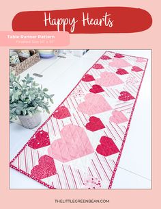 a table runner with hearts on it and the text happy hearts written in red above