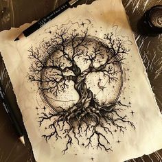 an ink drawing of a tree on paper