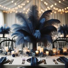 a table topped with lots of blue feathers and candles