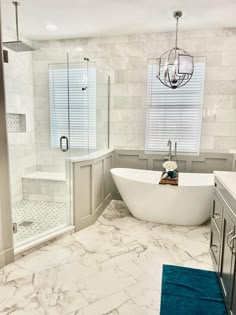 a white bath tub sitting next to a walk in shower