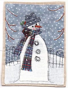 a snowman with a hat and scarf is standing in front of a snowy fence