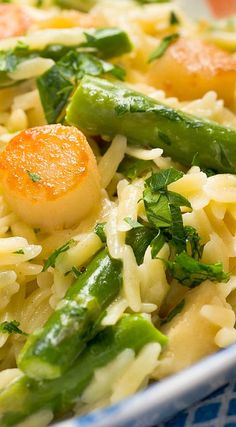 pasta with asparagus, carrots and parmesan cheese in a bowl