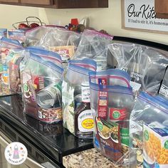 bags of food sitting on top of a counter in a grocery store, ready to be packed