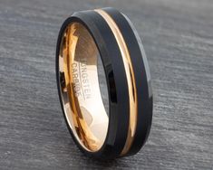 a black and gold wedding band with two tone inlays on the inside of it