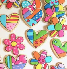 decorated cookies are arranged in the shape of hearts