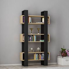 a bookshelf with several shelves and vases on the floor next to it