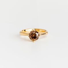 A classic round profile solitaire ring with an excellent cut brown diamond ✦ Material ✦ 18k yellow solid gold Brown Diamond: Excellent cut, 1 ct ✦ Details ✦ Bezel diameter: 7.9 mm (Model is wearing a grey diamond ring) - Ring size This price is for a ring in a size up to 9, if you need a bigger size please contact us for the price and details! We strongly suggest trying on rings in the same width to determine your size - with this wide of a band you may need a different ring size than your norma Brown Engagement Rings, Radiant Diamond Rings, Brown Diamond Ring, Round Profile, Grey Diamond Ring, Brown Rings, Brown Bracelet, Ring Ideas, Radiant Diamond