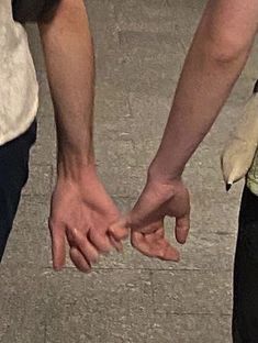 two people holding hands with the caption just lovers