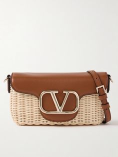 Part of Valentino Garavani's 'Locò' collection, this shoulder bag is woven from raffia, making it perfect for warmer months. It's trimmed with smooth leather and accented with the signature 'VLOGO'. Stow a couple of lipsticks, your phone and a cardholder inside. Designer Intrecciato Weave Shoulder Bag For Vacation, Designer Natural Straw Bag With Gold-tone Hardware, Luxury Natural Straw Bag With Gold-tone Hardware, Luxury Rectangular Straw Bag With Detachable Strap, Luxury Evening Straw Shoulder Bag, Designer Rectangular Straw Bag With Gold-tone Hardware, Luxury Leather Straw Bag With Detachable Strap, Designer Brown Straw Bag With Woven Leather, Designer Straw Bag With Gold-tone Hardware