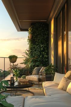 an outdoor living area with couches, tables and potted plants on the balcony