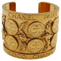 CHANEL by KARL LAGERFELD and VICTOIRE DE CASTELLANE vintage cuff bracelet featuring CC 31 Rue Cambon Paris Coins alterning with acanthus leaves and embossed C H A N E L P A R I S C O C O C H A N E L on the rims. Gold tone metal hardware. Collection n°23 (year : 1988). Embossed CHANEL 2 3 Made in France. Indicative measurements : inner measurements approx. 5.8 cm x 4.7 cm (2.28 inches x 1.85 inches) / width approx. 5.2 cm (2.05 inches). NOTES - This is a preloved item, therefore it might have imp 31 Rue Cambon, Victoire De Castellane, Vintage Cuff Bracelet, Acanthus Leaves, Chanel 2, Chanel Vintage, Acanthus Leaf, Vintage Chanel, Metal Hardware