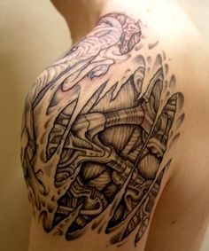 a man's shoulder with some tattoos on it