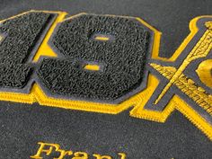 Black and gold sweatshirt Black Varsity T-shirt For Fall, Black Varsity Tops With Embroidered Logo, Black Top With Letter Embroidery For Streetwear, Black Sweater With Letter Embroidery For Winter, Black Letter Embroidery T-shirt For Streetwear, Black Hoodie With Letter Embroidery For Streetwear, Varsity Black Sweatshirt With Embroidered Logo, Black College Hoodie With Embroidered Logo, Black Varsity Sweater For College