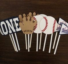 some baseball themed cupcake toppers on a table