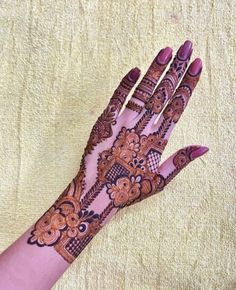 a woman's hand with henna on it