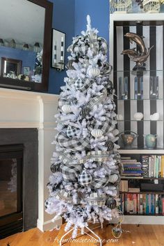 a white christmas tree with black and silver ornaments