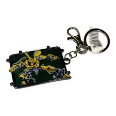 a keychain with an image of a yellow and black robot on it's side