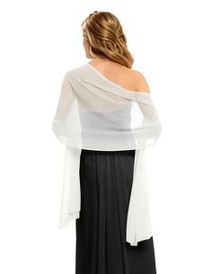 a woman in a white top and black skirt is looking at the back of her dress