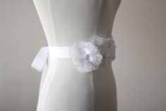 "An accessory to complement your beautiful wedding dress Flowers made of organza. The belt made ribbon and length is approximately 80\"dimensions, width is 1,18\" Pearl or rhinestone can be used according to your preference in the middle of the flowers . Belt in the first photo is the color of ivory. Other photos are white. Please feel free to contact for questions and requests. PACKAGE ARE SENT BY FAST SHIPPING COMPANY WITHIN 3 TO 4 BUSINESS DAYS, TO UNITED STATES, TO CANADA, TO UNITED KINGDOM, Elegant Bridal Belt With Flower Decoration For Wedding, Elegant Ribbon Bridal Belt For Wedding, Elegant Bridal Belt With Flower Decoration, White Bridal Belt With Ribbon For Wedding, Fitted Bridal Belt With Ribbon For Wedding, Wedding Dress Flowers, Wedding Dress Belt, Wedding Sash Belt, Wedding Dresses With Flowers