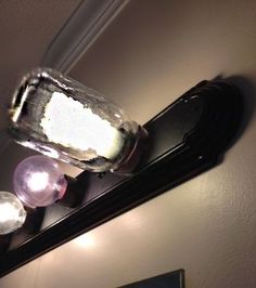 a bathroom mirror with powdered sugar on top of it and a light above the mirror