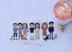 a cross - stitch family is shown with a pink flower and the word family written on it