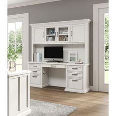 a white desk with drawers and a computer monitor