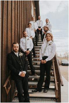 a group of men standing on top of stairs