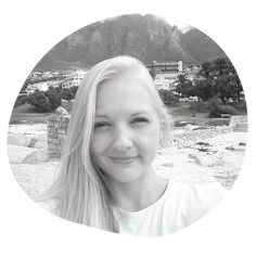 a black and white photo of a woman with long blonde hair smiling at the camera