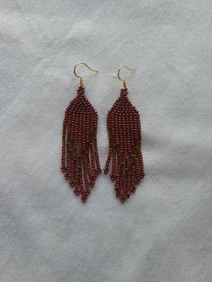 *All earring hooks are marked 925 sterling silver, the gold colored ones are gold plated silver*  The color of these earrings appear more red than they are in the photo. They are a deeper earthy red in person* These earrings are bright and eye catching making them a fun addition to any outfit or costume for a festival.     All of our earrings are hand selected directly from Indigenous artisans in Mexico, handmade with love and intention. Festive Earrings With Gold Beads, Handmade Round Bead Earrings For Celebration, Gold Beaded Sterling Silver Earrings, Beaded Earrings With Round Beads For Celebration, Traditional Adjustable Earrings With Gold Beads, Gold Beaded Dangle Earrings For Gifts, Celebration Dangling Beads Drop Earrings, Celebration Drop Earrings With Dangling Beads, Brown Dangling Beads Jewelry For Gift