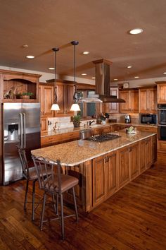 a large kitchen with wooden cabinets and stainless steel appliances