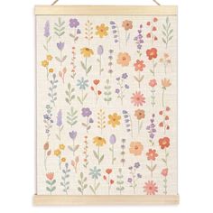 a white wall hanging with colorful flowers on it