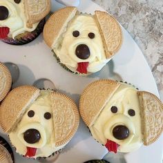 cupcakes shaped like dogs with oreos on them and one has a dog's face