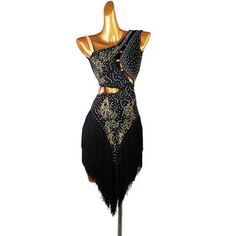 a black and gold flap dress on a mannequin with beads, fringes and sequins