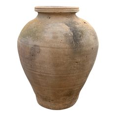 a large brown vase sitting on top of a white surface