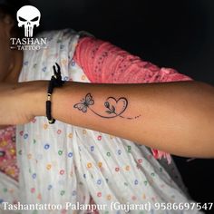 a woman with a butterfly tattoo on her arm and the words tashuttoo paapur gouau