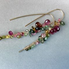 A pair of watermelon tourmaline earrings custom made set in 14K gold-filled wires.  The look is pretty and elegant.  Nicest quality natural gemstones wire wrapped on 20 gauge hoops. These faceted tourmaline beads and briolettes are attached one at a time, covering the full-colour range of the gemstone.  The earrings are approx. 2.25 inches in length. These earrings are handmade by me in Toronto. Each one is unique.  All metal components used are 14K gold-filled.   You will receive a similar pair Wire Jewelry Earrings, Ruby Necklace Pendant, Bar Jewelry, Hoops Gold, Tourmaline Earrings, Tourmaline Beads, Jewelry Studio, Watermelon Tourmaline, October Birthstone